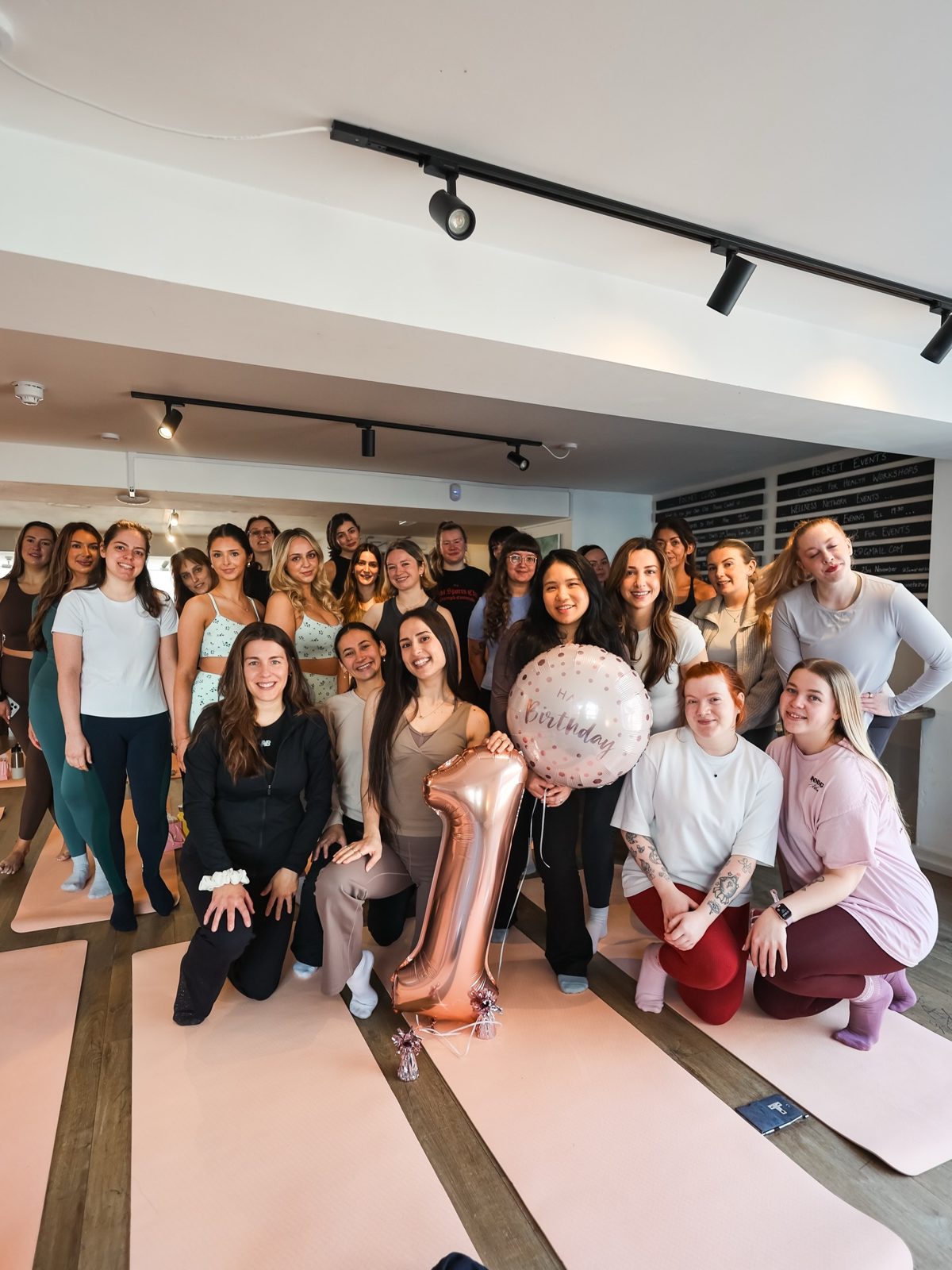 Around twenty-five Casa Pilates members gathered in the studio with a number 1 balloon